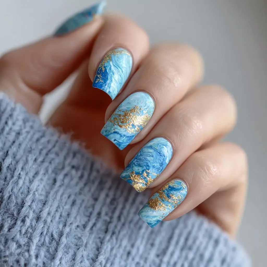 blue and gold almond medium nails with abstract and glossy