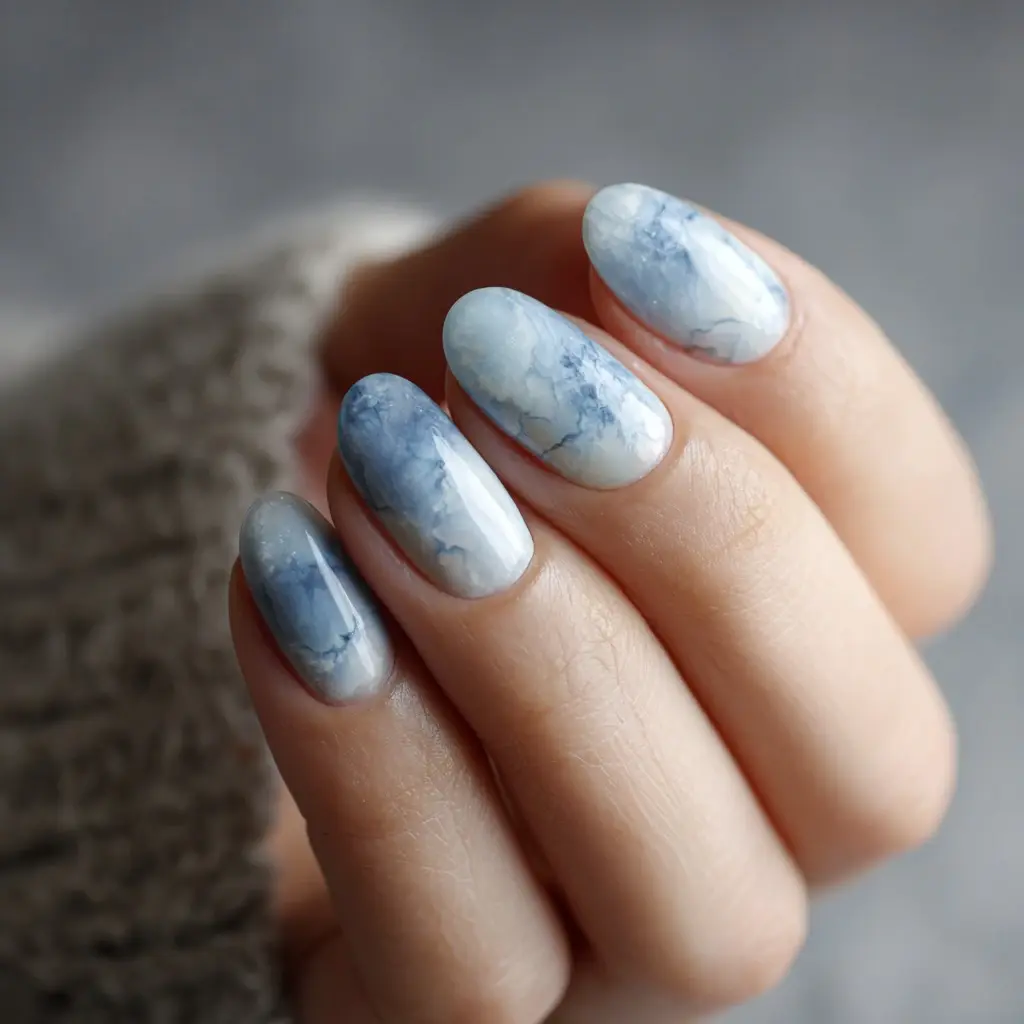 blue and white almond medium nails with abstract and glossy