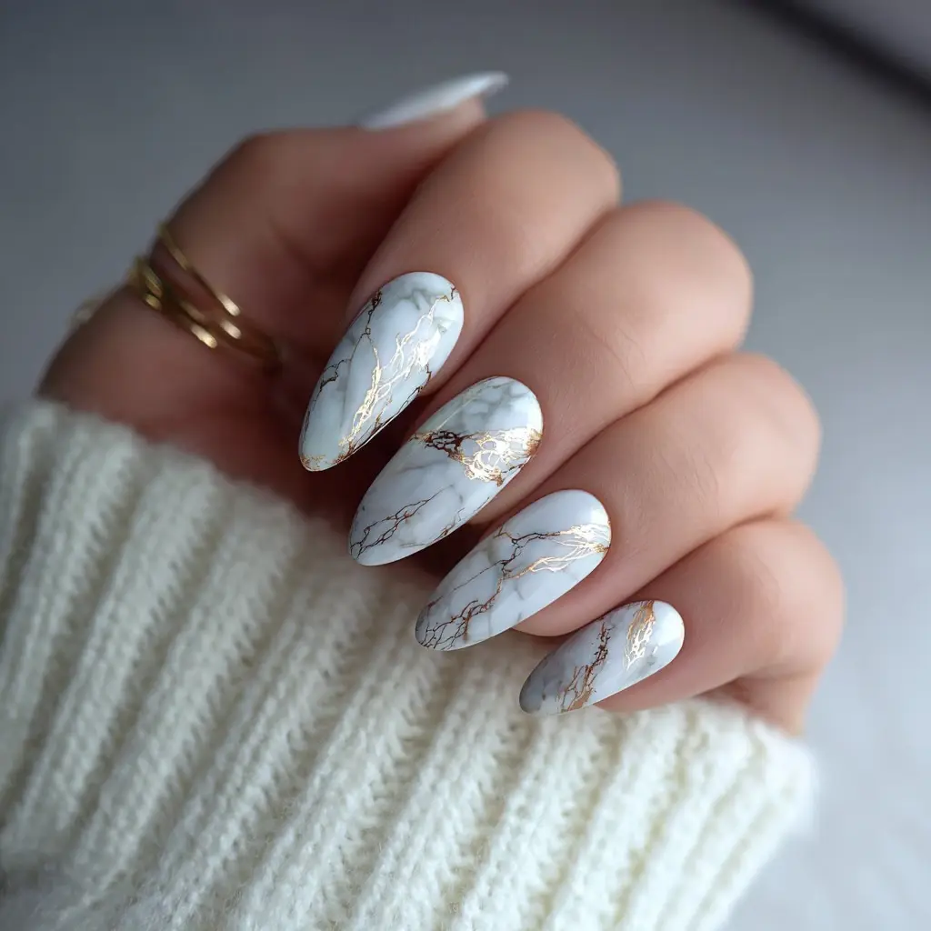 white and gold almond medium nails with abstract and glossy